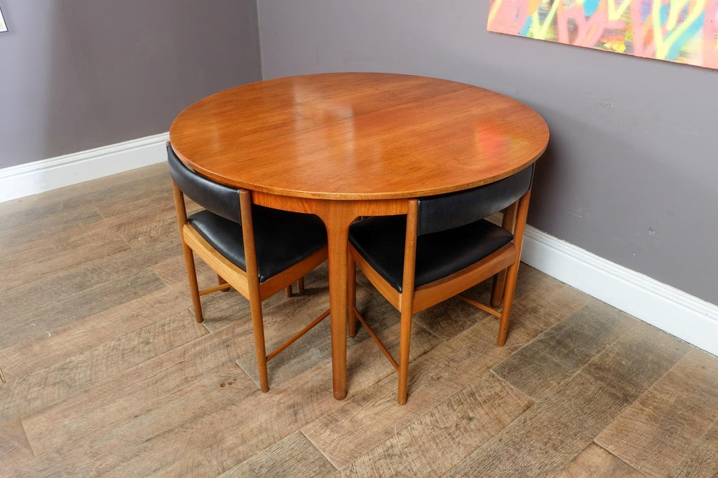 A H McIntosh Teak Extending Circular table and 4 Tuck Under Chairs
