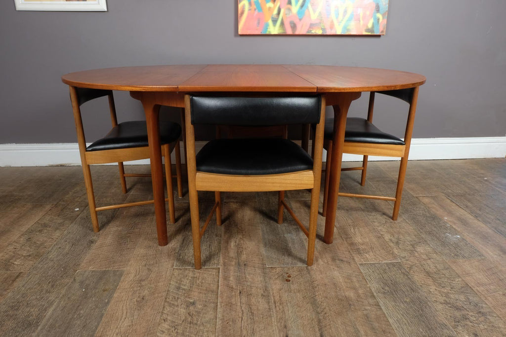 A H McIntosh Teak Extending Circular table and 4 Tuck Under Chairs