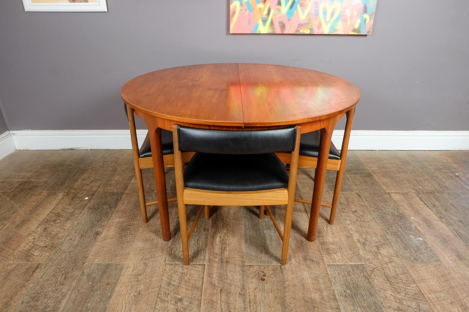 A H McIntosh Teak Extending Circular table and 4 Tuck Under Chairs