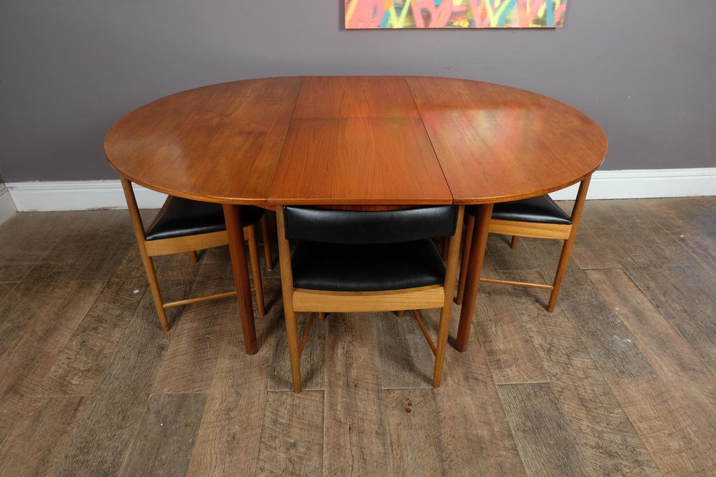 A H McIntosh Teak Extending Circular table and 4 Tuck Under Chairs