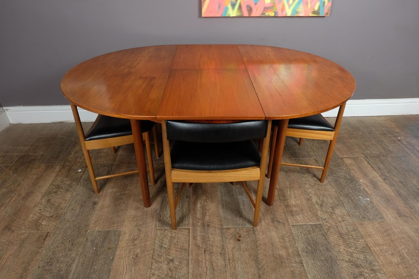 A H McIntosh Teak Extending Circular table and 4 Tuck Under Chairs