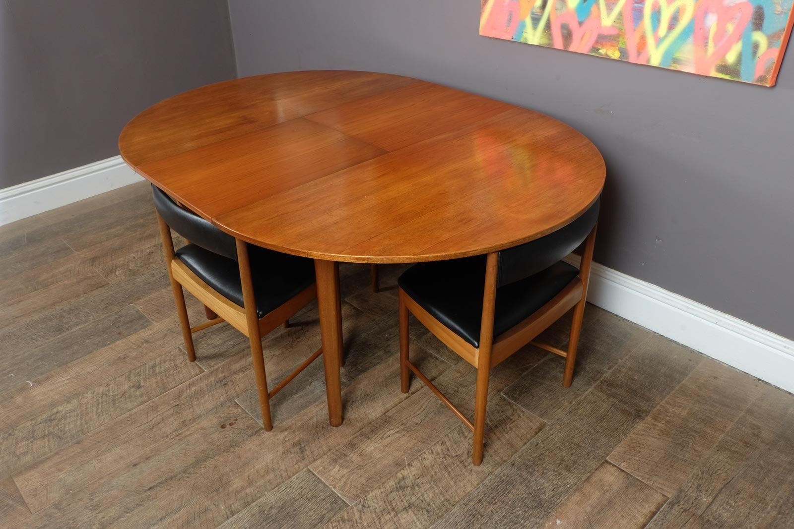 A H McIntosh Teak Extending Circular table and 4 Tuck Under Chairs