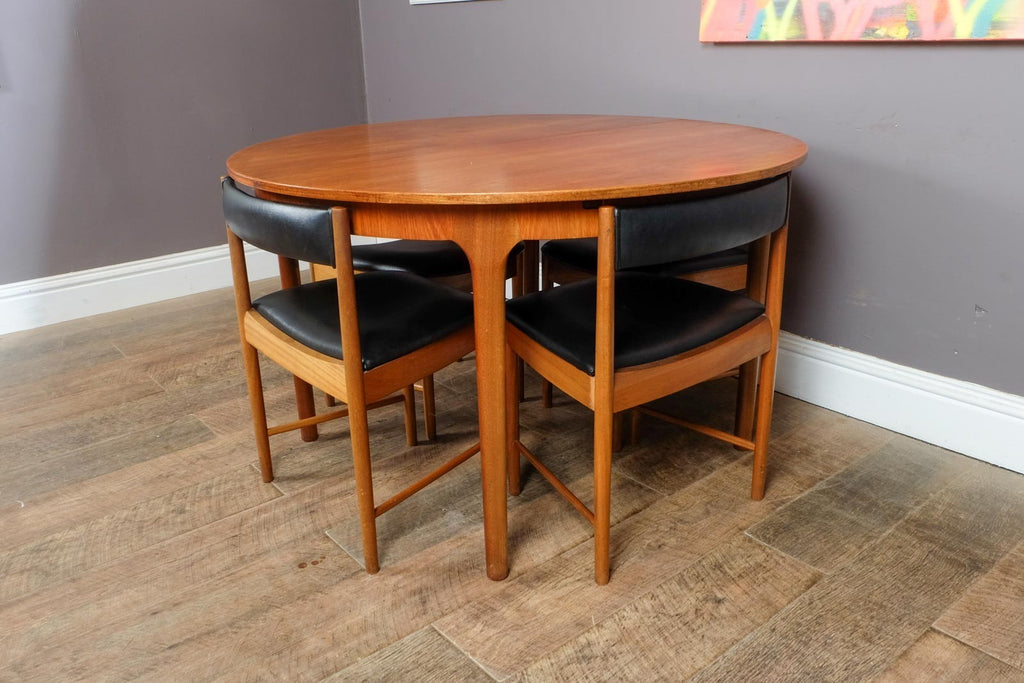 A H McIntosh Teak Extending Circular table and 4 Tuck Under Chairs