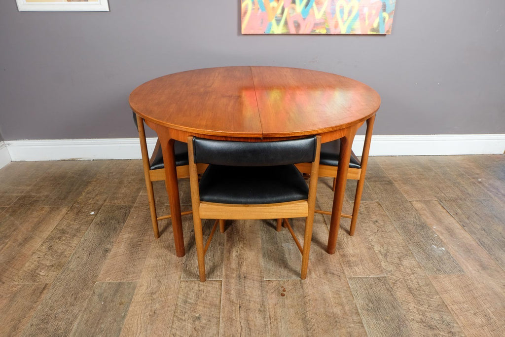A H McIntosh Teak Extending Circular table and 4 Tuck Under Chairs