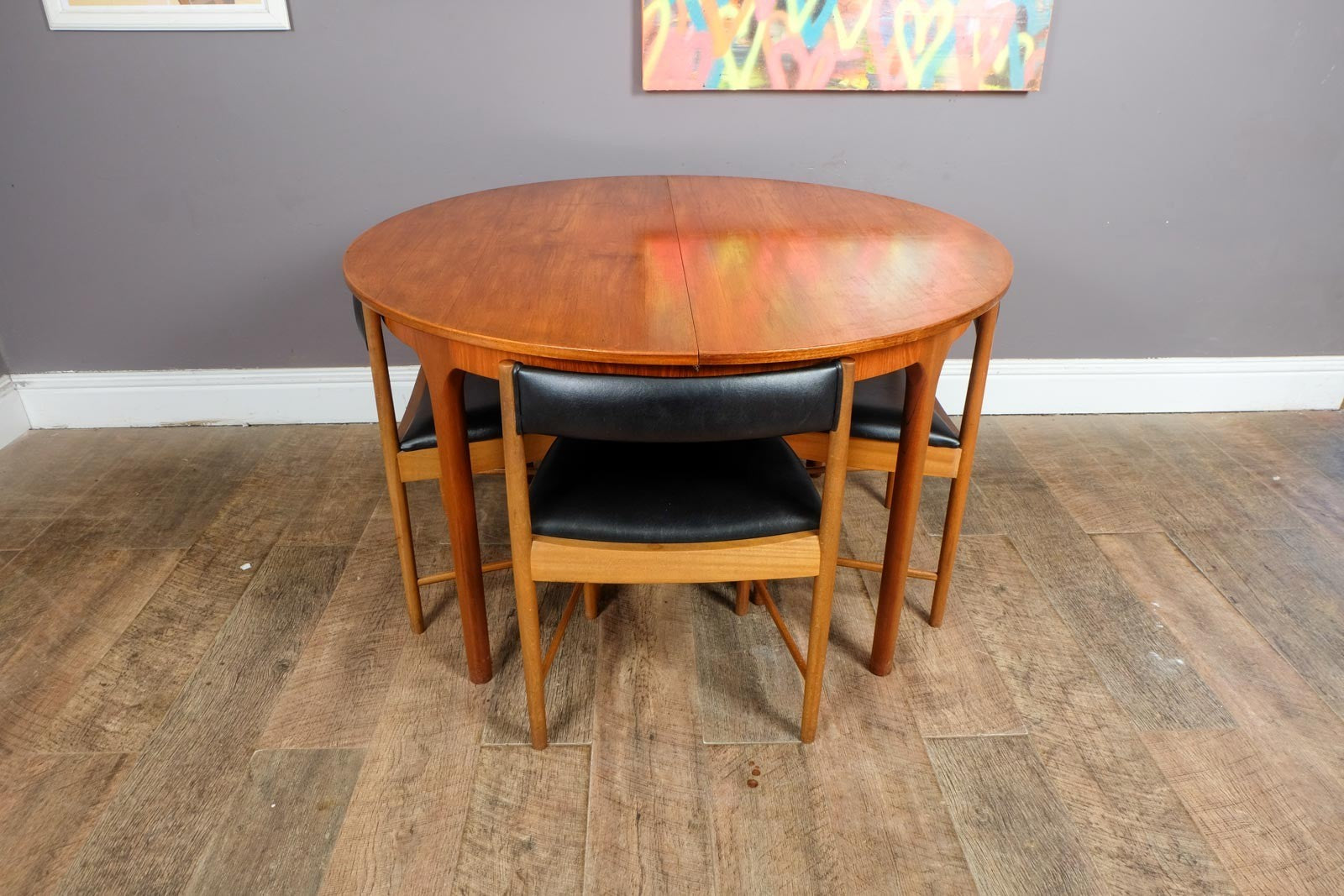 A H McIntosh Teak Extending Circular table and 4 Tuck Under Chairs