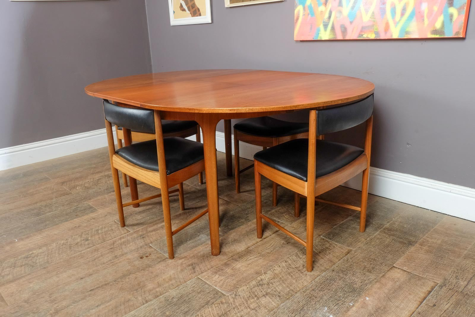 A H McIntosh Teak Extending Circular table and 4 Tuck Under Chairs